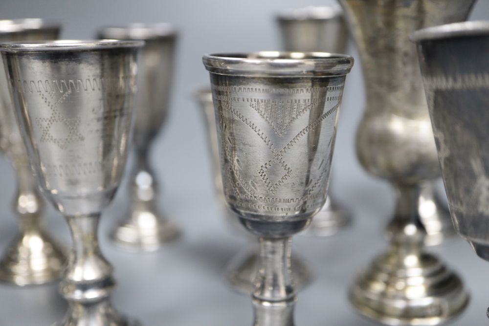 Eleven assorted mainly early 20th century silver kiddush cups and two similar Russian cups, gross 11.25oz.
